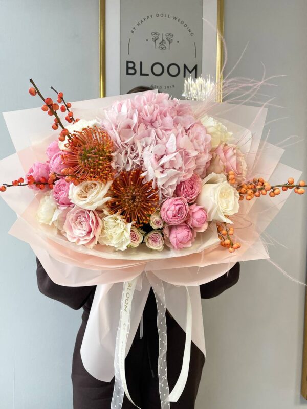 Романтичний букет з рожевою гортензією, трояндами та акцентними квітами у фірмовій упаковці Bloom